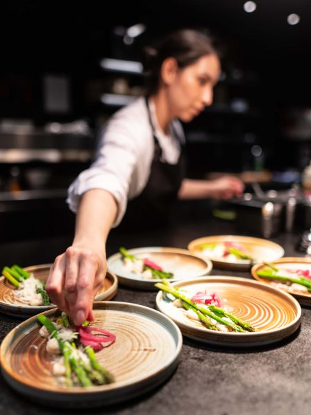 Image of someone plating food with asparagus